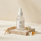 Angle : Vue à 45°  Le flacon Beauty of Joseon Glow Deep Serum posé sur un socle en travertin beige entouré d'épis de riz, de fleurs blanches et de quelques gouttes d'eau. Fond crème minimaliste, lumière naturelle diffuse, ombres douces, photographie e-commerce haut de gamme, rendu photoréaliste. (gemini-3.1-flash-image-preview)