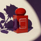 Un plan moyen à 45 degrés du flacon de image_8.png posé sur un fond minimaliste de couleur crème mat. Un projecteur puissant projette l'ombre graphique et nette de pétales de rose pourpre directement sur le mur arrière et sur le corps rouge laqué de image_8.png. L'étiquette blanche 'MONACO' reste parfaitement illuminée et nette. Style : Studio packshot contemporain et graphique. (gemini-3.1-flash-image-preview)