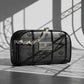 Un plan moyen à 45 degrés de la trousse noire de image_19.png disposée sur un sol en béton ciré gris clair au fini mat. Un projecteur de studio projette l'ombre graphique, nette et géométrique de lignes architecturales structurées directement sur le mur arrière et sur le flanc de image_19.png. La chaîne d'argent de image_19.png capte une lumière rasante ultra-réaliste. Style : Studio packshot contemporain. (gemini-3.1-flash-image-preview)