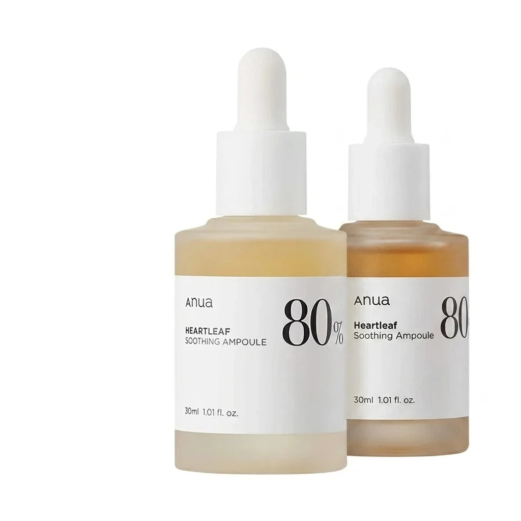 Studio packshot of two Anua Heartleaf Soothing Ampoule 30ml bottles arranged together. One bottle in a straight front view, the second bottle slightly behind it at a three-quarter angle to show depth. Clean layout, professional cosmetic branding display. Pristine glass materials, soft corporate lighting, sharp focus throughout. Isolated on a perfect, solid white background, commercial grade. (gemini-3.1-flash-image-preview)