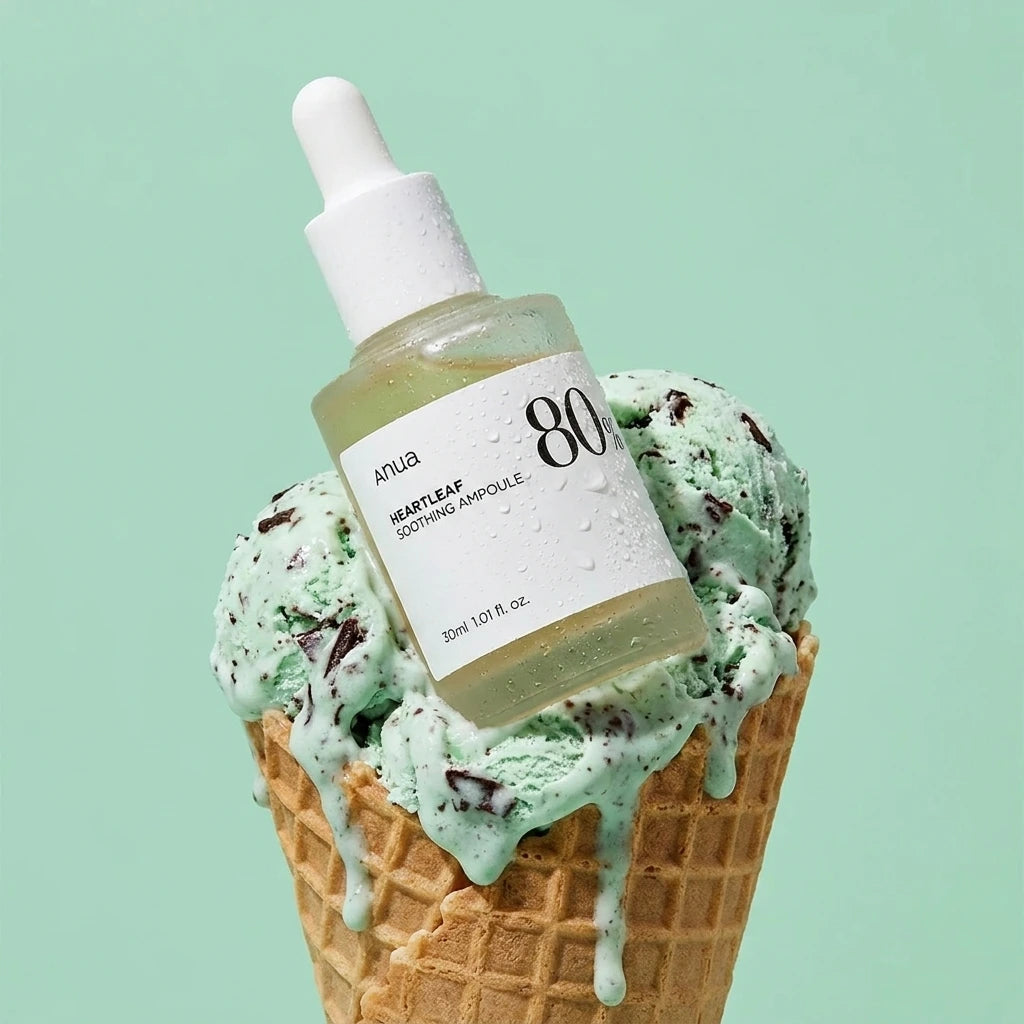 High-end e-commerce product photography of the "Heartleaf 80% Soothing Ampoule" glass dropper bottle. The bottle is nestled inside a giant scoop of melting mint-chocolate chip ice cream on a waffle cone. Soft condensation on the glass bottle. Background is a solid pastel mint green studio backdrop. Playful, refreshing, commercial cosmetics ad look, sharp focus, 1:1 aspect ratio. (gemini-3-pro-image-preview)