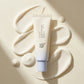 Angle : vue plongeante 30°  Beauty of Joseon Relief Sun SPF50+ surrounded by smooth sunscreen swirls on a creamy ivory surface, natural daylight, luxury skincare editorial photography, realistic texture details, premium Korean beauty campaign, highly detailed cosmetic advertising (gemini-3-pro-image-preview)