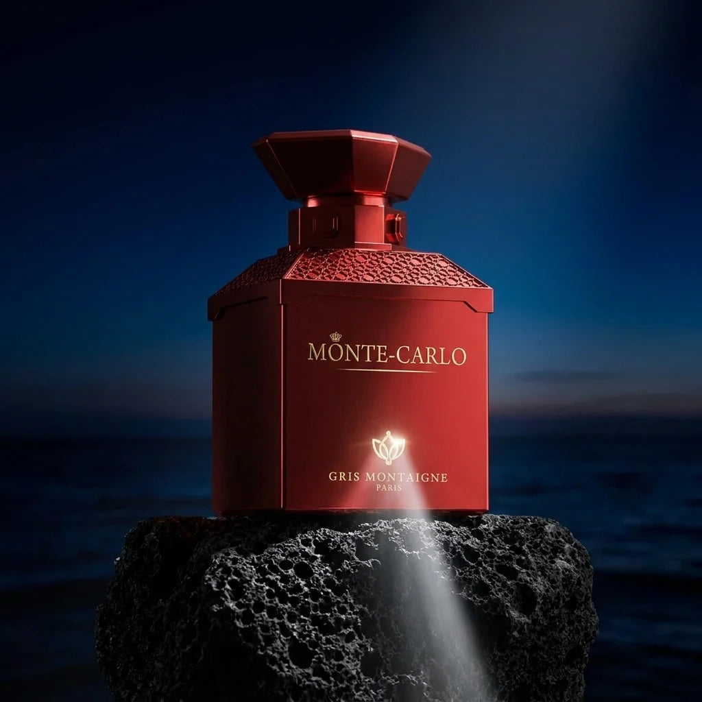 Un plan large en contre-plongée (vue basse) plaçant le flacon de image_27.png sur un piédestal de roche volcanique noire poreuse. Le fond est un dégradé de bleu nuit et de noir évoquant un crépuscule sur la mer Méditerranée. Un faisceau de lumière blanche et directionnelle frappe directement le logo doré au bas de image_27.png, le rendant parfaitement net, lisible et haut de gamme. Style : Photographie de produit dramatique et conceptuelle. (gemini-3-pro-image-preview)