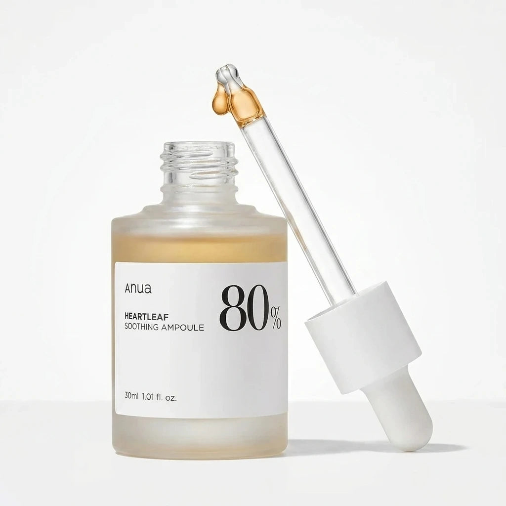 Professional skincare product photography. Anua Heartleaf 80% Soothing Ampoule 30ml bottle with the dropper pipette pulled out and placed next to it. A single, clean amber droplet is visible at the tip of the glass pipette. Hyper-realistic glass shader, natural liquid texture, sharp details on the bottle label. Bright studio lighting, isolated on a seamless, pure white background. (gemini-3-pro-image-preview)